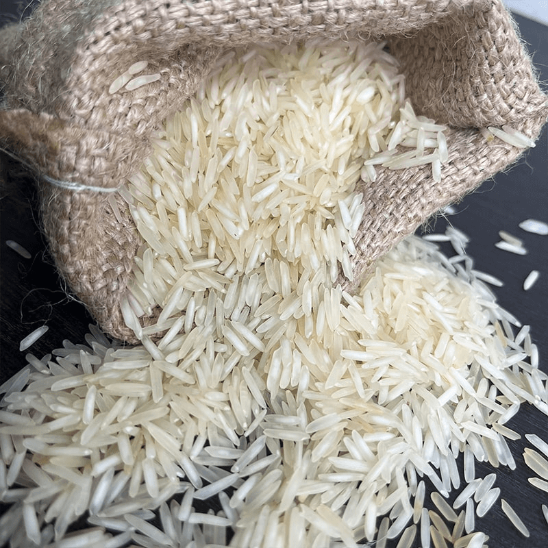 Long grain basmati rice spilling from a linen sack